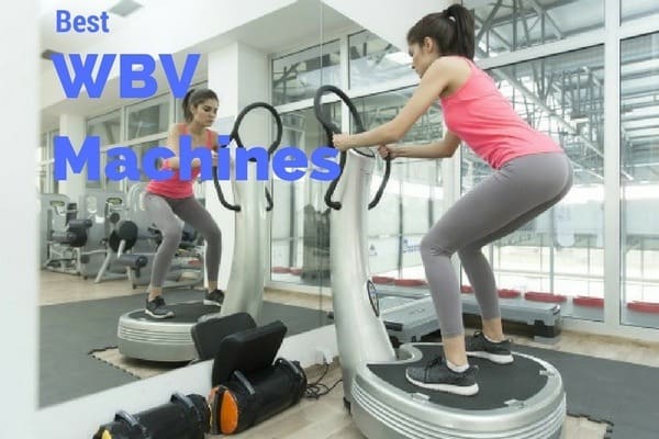 Women standing on a WBV machine in a gym