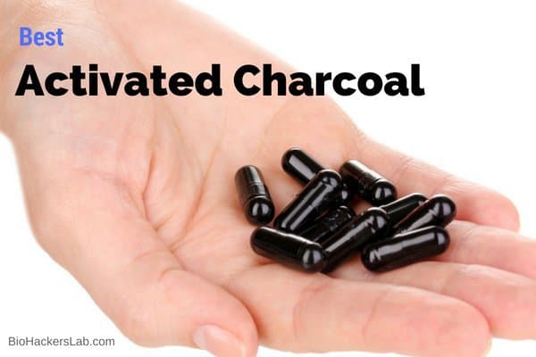 Activated charcoal capsules in a hand