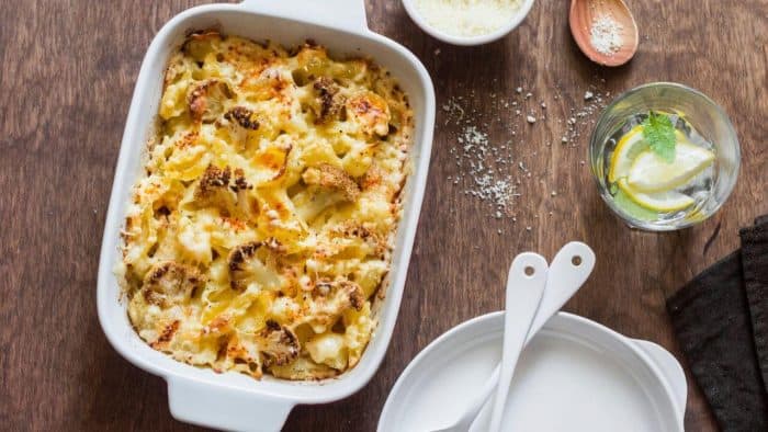Cauliflower mac and cheese dish on a wood kitchen counter top